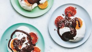 three finished dishes of Tom Hunt Aquafaba meringues covered in blood orange and chocolate sauce