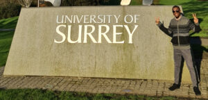 Person standing outside University of Surrey entrance